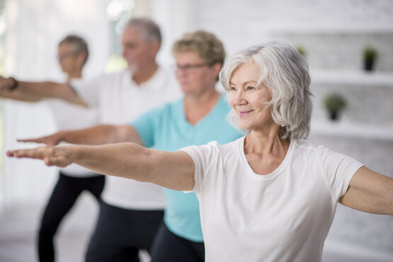 Several patients practising Tai Chi in the therapy room